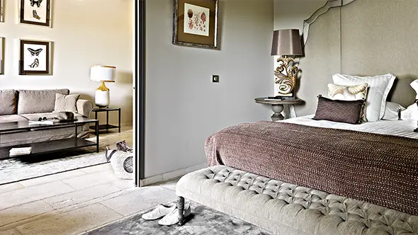 Spacious suite in beige tones with a separate living room and bay views.