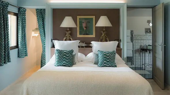 Luxurious suite with turquoise accents, a terrace, and magnificent views.