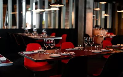 Stylish interior of Altayaki fusion restaurant with set tables and red chairs