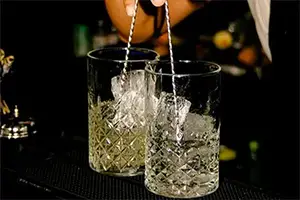 Bartender preparing cocktails at Django bar in Courchevel