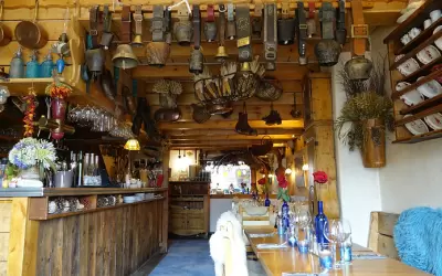 Traditional alpine interior of La Chaumiere restaurant with cowbells