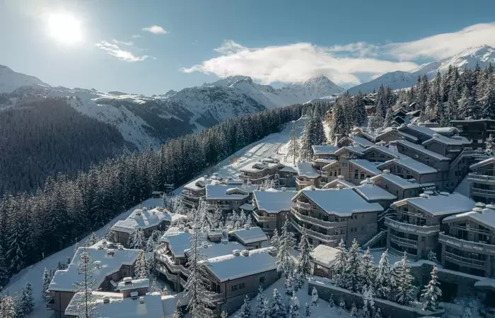 Aerial view of the hotel hamlet in winter at Le K2 Palace, Courchevel 1850