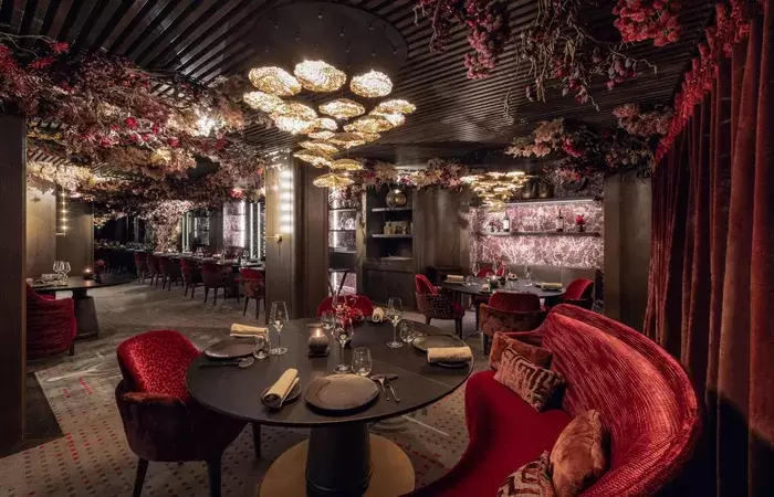 The red salon with banquette seating at Le Bottleneck, Le K2 Palace, Courchevel 1850