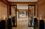 Lattice-panelled corridor leading in from the entrance at Aman Le Melezin
