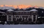Aman Le Melezin at dusk below alpenglow on the peaks above Courchevel 1850