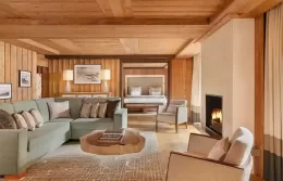 Elegant Deluxe Suite bedroom with access to a snowy terrac