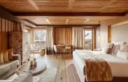 Bright Prestige Junior Suite interior with a large bed and stylish furniture.