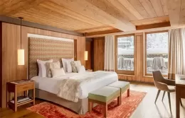 Cozy living room of the Prestige Suite with a fireplace and dining area.