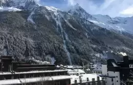 View over Chamonix rooftops to the snowy mountains from a Superior Room, Hotel Mont-Blanc