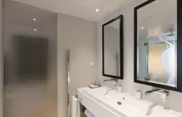 Prestige Room bathroom with double washbasin and black-framed mirrors, Hotel Mont-Blanc Chamonix