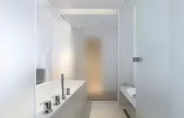 Bathtub and shower inside the frosted ice cube of a Junior Suite, Hotel Mont-Blanc Chamonix
