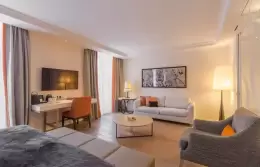 Sitting area with sofa, armchair and coffee table in a Junior Suite, Hotel Mont-Blanc Chamonix