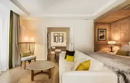 Junior Suite Mont-Blanc with round table, white sofa and bed, Hotel Mont-Blanc Chamonix