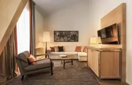 Duplex Suite living room with corner sofa under sloping beams, Hotel Mont-Blanc Chamonix