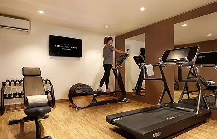 Fitness room with a treadmill, an elliptical trainer and dumbbells at Hotel Mont-Blanc Chamonix