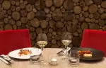 Plated dishes and glasses of white wine in the hotel restaurant, Hotel Mont-Blanc Chamonix