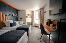Twin beds and desk in a Double Room with slopes view, Fahrenheit Seven Val Thorens
