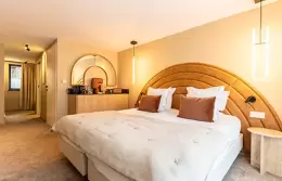 Junior Suite bedroom with dressing area and coffee tray at Fahrenheit Seven Courchevel