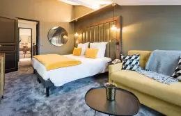 Bedroom and seating area of the Duplex Top Floor Suite at Fahrenheit Seven Courchevel