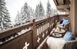 Prestige Suite balcony with armchairs overlooking snowy fir trees, Lys Martagon, Courchevel 1850