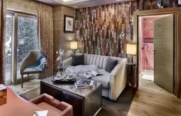 Separate sitting area with a sofa in Deluxe Room 1 at Lys Martagon, Courchevel 1850