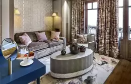 Junior Suite 1 sitting area with a sofa and an oval coffee table, Lys Martagon, Courchevel 1850