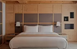 Wooden Zeno suite bedroom at Aman Rosa Alpina hotel.