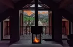 Room fireplace with a view of village and mountains.
