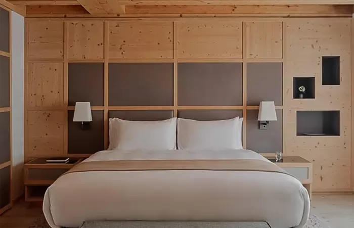 Wooden Zeno suite bedroom at Aman Rosa Alpina hotel.