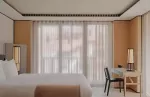 Bedroom in a deluxe suite at Aman Rosa Alpina.