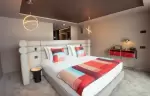 Double room interior with cocoon headboard at Fahrenheit Seven Les Menuires