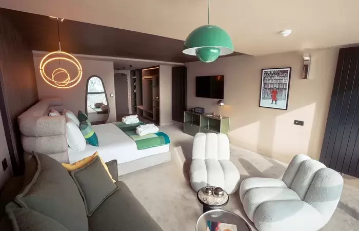 Suite with king-size bed and lounge seating at Fahrenheit Seven Les Menuires