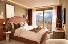 Superior Room with a terracotta headboard and a balcony door at Barma Hotel & Spa, La Tania