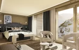 Junior Suite with two armchairs and a small table by the window at Barma, La Tania