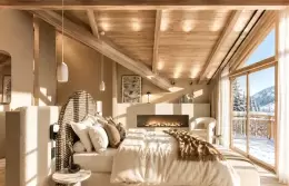 Bedroom with a fireplace in the Master Suite half of the Alpine Suite at Barma, La Tania