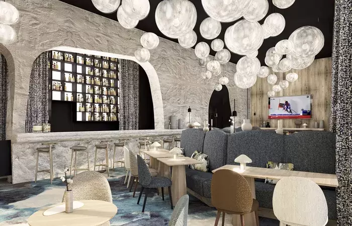 Bar with glass globe lights and a stone-effect counter at Barma Hotel & Spa, Courchevel La Tania