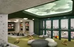 Children play area with bookshelves and pebble cushions at Barma Hotel & Spa, La Tania