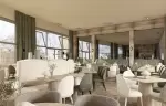 Dining room with upholstered chairs beside large windows at La Table de Barma, La Tania