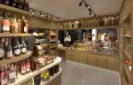 Barma delicatessen with wines, cheeses and pastries on wooden shelves, Courchevel La Tania