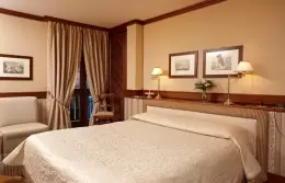 A Classic Room with a cream bedspread and curtained balcony door, Hotel Hermitage, Breuil-Cervinia
