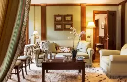 The living room of a Prestige Suite with a sofa and armchairs, Hotel Hermitage, Breuil-Cervinia
