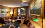 Sofas and large mountain paintings in the bar lounge at Hotel Hermitage, Breuil-Cervinia