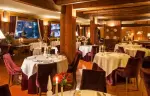 Laid tables in the La Chandelle dining room at Hotel Hermitage, Breuil-Cervinia