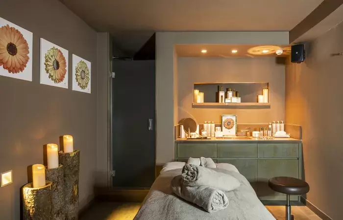 A spa treatment room lit with candles at Hotel Hermitage, Breuil-Cervinia