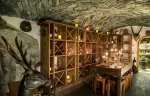 The vaulted stone wine cellar with a stag sculpture at Hotel Hermitage, Breuil-Cervinia
