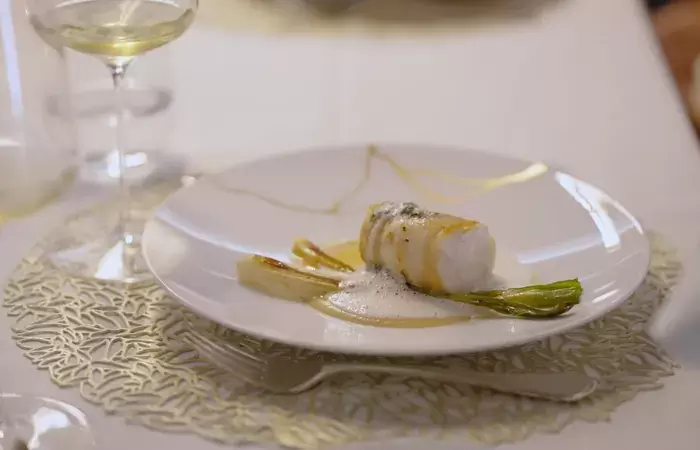 A plated fish course with green asparagus at No. 14 Verbier