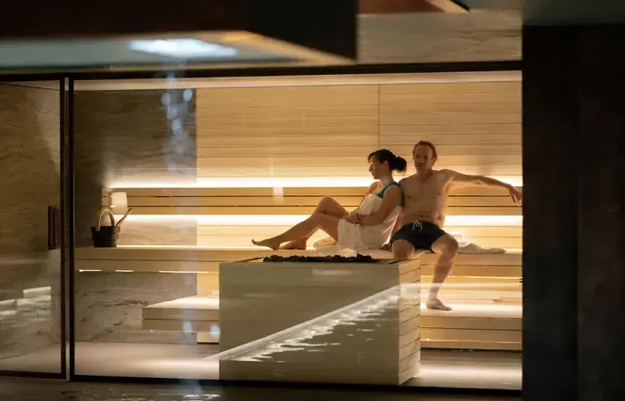Two guests relaxing in the sauna of the chalet spa at No. 14 Verbier